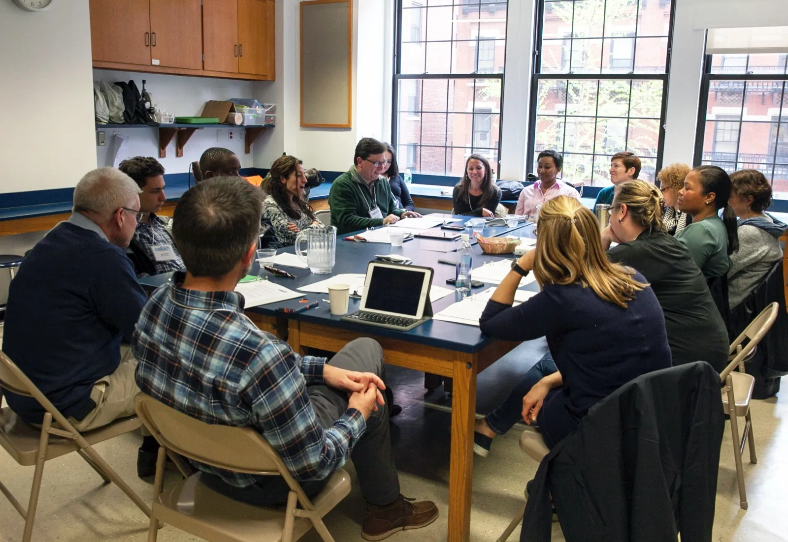 Pollyanna participants in conversation at a workshop table