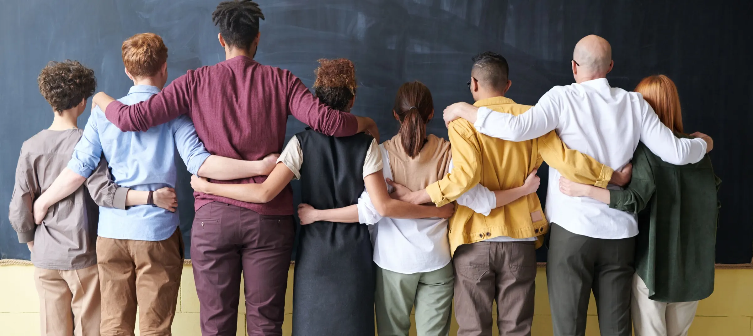 Pollyanna community members standing together with linked arms